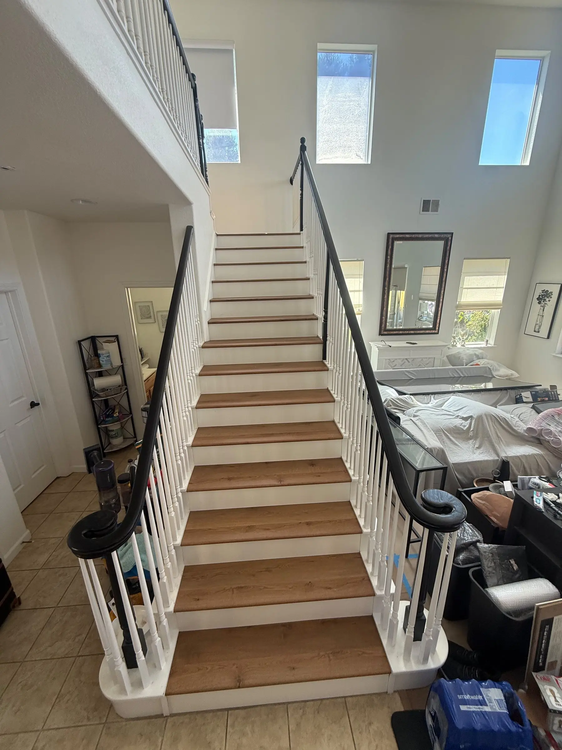After: Bare plywood staircase finished with warm oak treads and crisp white risers