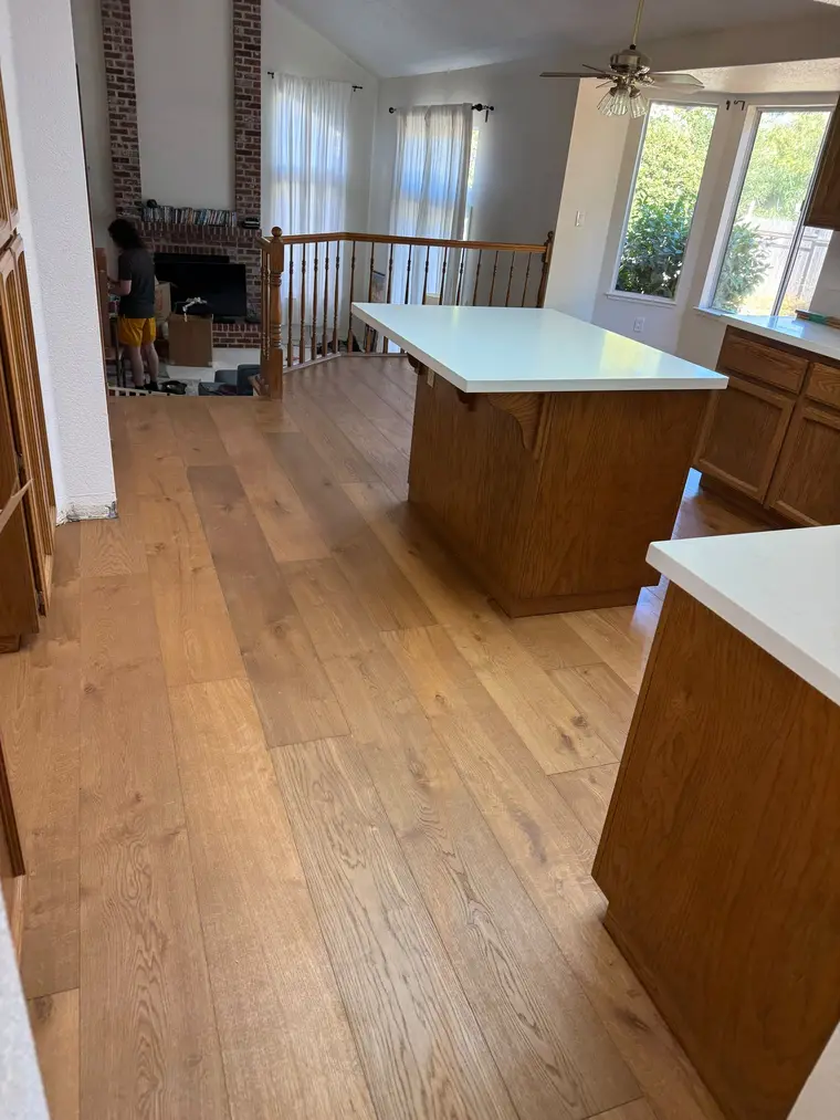 After: Gutted kitchen subfloor transformed with wide plank oak look flooring
