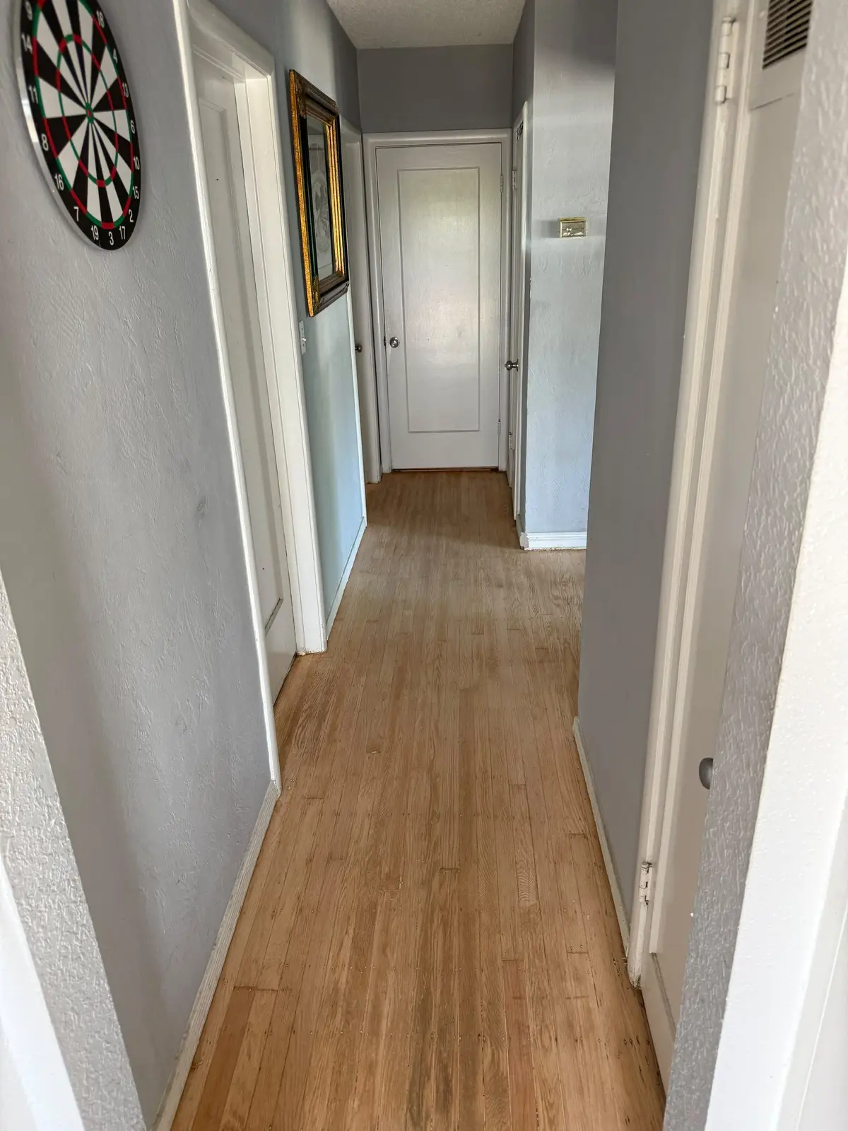 The same hallway after sanding, finished in a warm natural tone